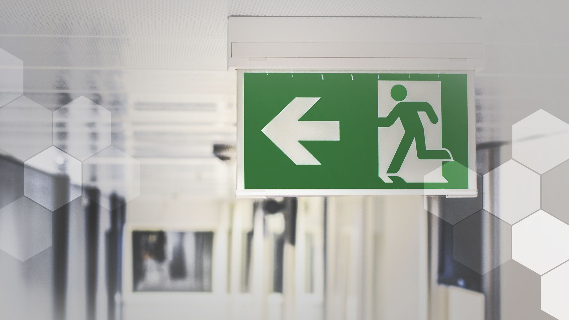 A photo of an emergency-exit sign on a corridor ceiling – because call center attrition is that bad.
