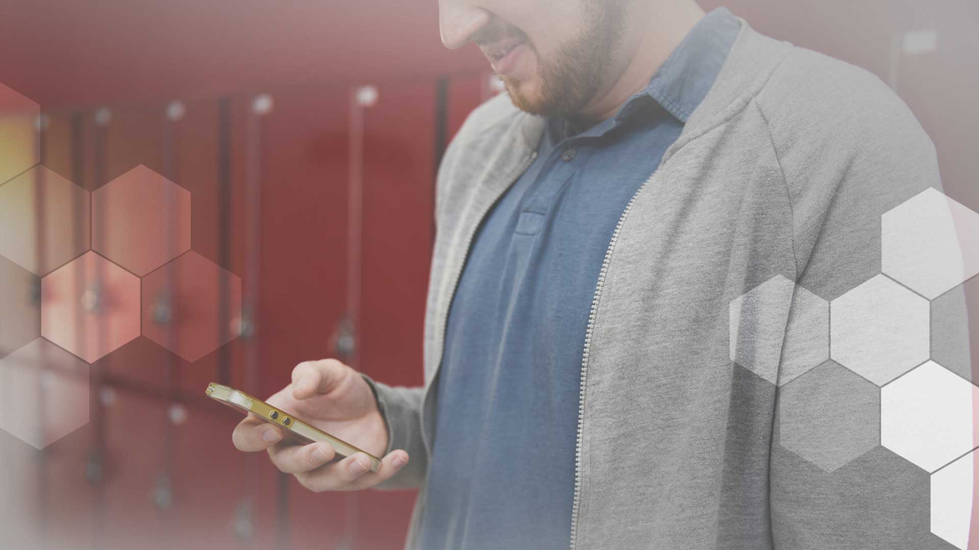 A man looks down at his phone, totally about to up your call abandonment rate.